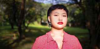 Image of a young woman in a red shirt