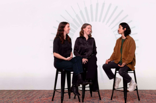 Three people sitting on stools